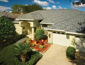 A shingle family home in Florida with yellow stucco siding and a gray tile roof.