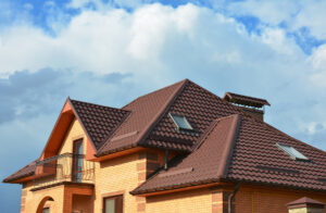 A home with a stylish brown metal roof against a blue sky