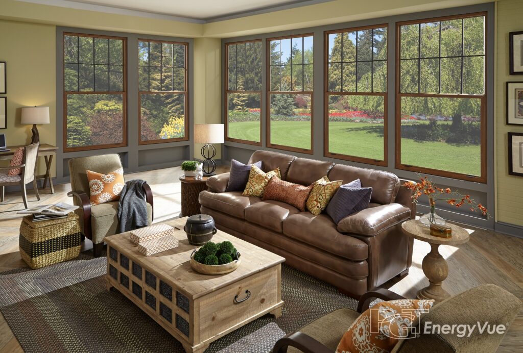 A bright living room with multiple large windows overlooking the outdoors