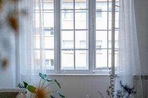 Sunny day through window. Old window in white apartment home decor.