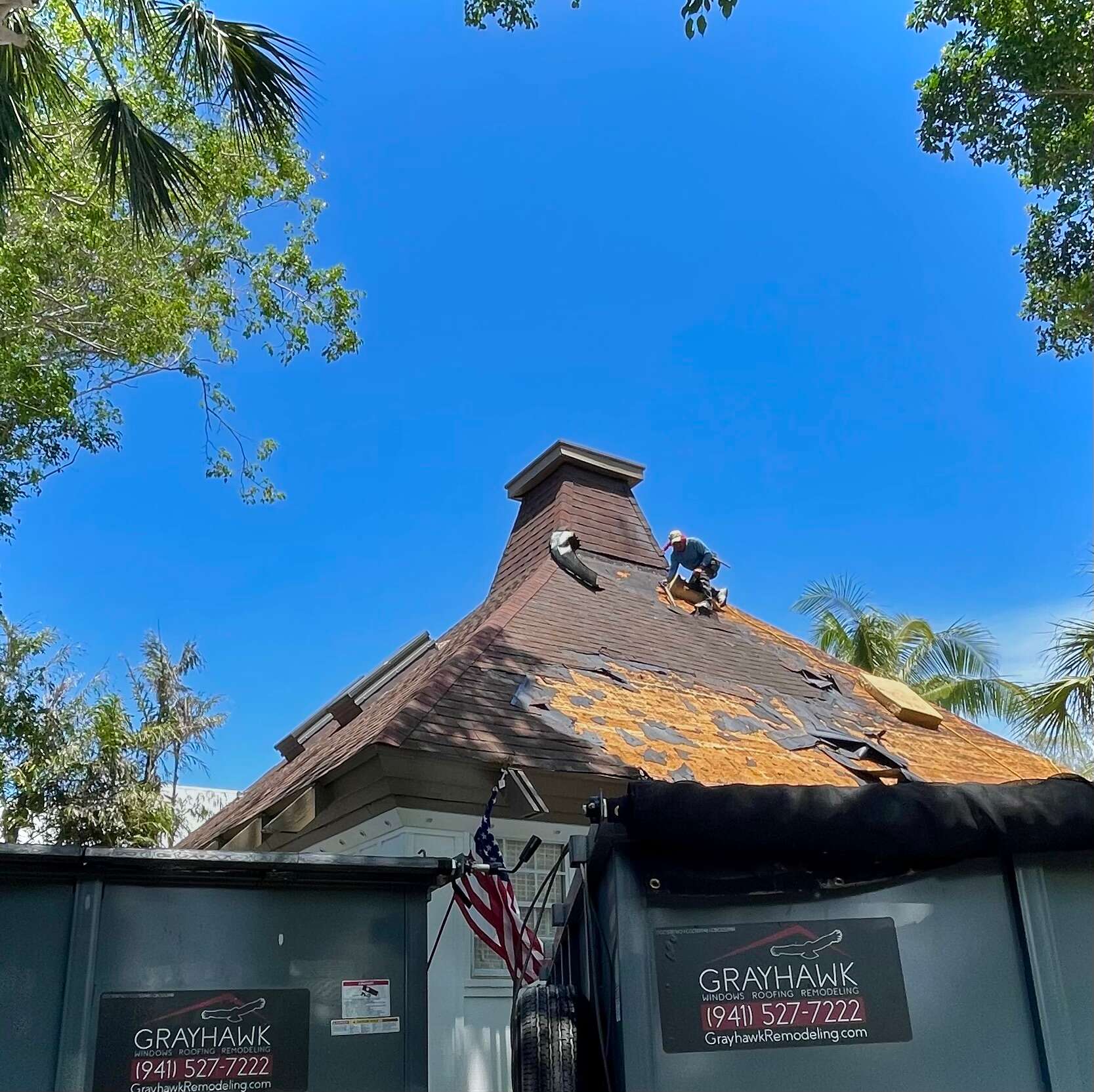 A roofer from Grayhawk Remodeling works on a roof replacement project.